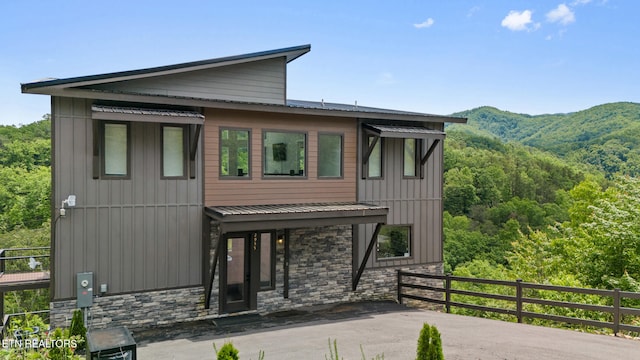 2955 Lightning Strike Dr, Sevierville, TN 37862 - contemporary home with stone siding, a mountain view, and board and batten siding