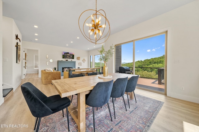 2955 Lightning Strike Dr, Sevierville, TN 37862 - dining space featuring light wood-style floors, a chandelier, baseboards, a fireplace, and recessed lighting