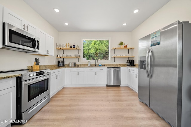 2955 Lightning Strike Dr, Sevierville, TN 37862 - kitchen with appliances with stainless steel finishes, open shelves, a sink, light stone counters, and recessed lighting