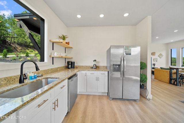 2955 Lightning Strike Dr, Sevierville, TN 37862 - kitchen with stainless steel appliances, a sink, light wood finished floors, white cabinets, and recessed lighting
