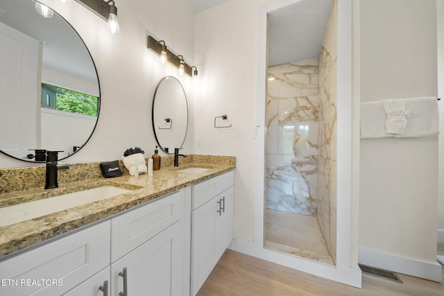 2955 Lightning Strike Dr, Sevierville, TN 37862 - full bathroom with a marble finish shower, double vanity, wood finished floors, and baseboards