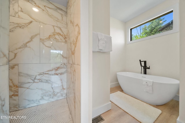 2955 Lightning Strike Dr, Sevierville, TN 37862 - full bath featuring a freestanding bath, a marble finish shower, and wood finished floors
