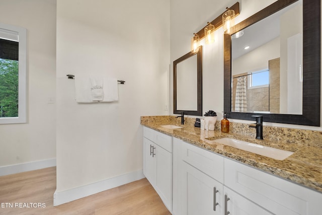 2955 Lightning Strike Dr, Sevierville, TN 37862 - full bathroom with wood finished floors, double vanity, tiled shower, and baseboards