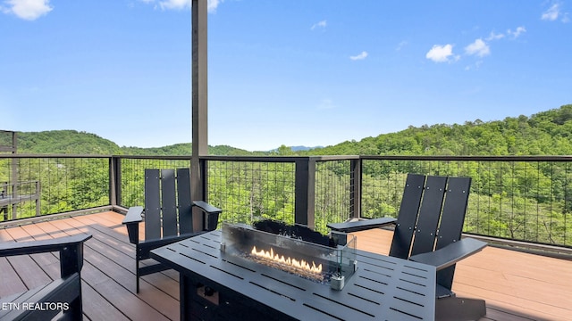 2955 Lightning Strike Dr, Sevierville, TN 37862 - deck featuring a fire pit, a mountain view, and a view of trees