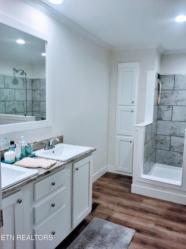 1748 Circle Lake Dr, Dandridge, TN 37725 - full bathroom with double vanity, tiled shower, crown molding, wood finished floors, and recessed lighting