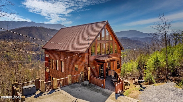 204 Pinnacle Dr, Gatlinburg, TN 37738 - view of front of house with a mountain view, log exterior, metal roof, and a gate