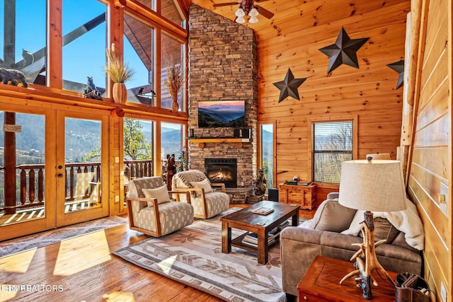 204 Pinnacle Dr, Gatlinburg, TN 37738 - living area with high vaulted ceiling, healthy amount of natural light, a fireplace, wood finished floors, and a ceiling fan