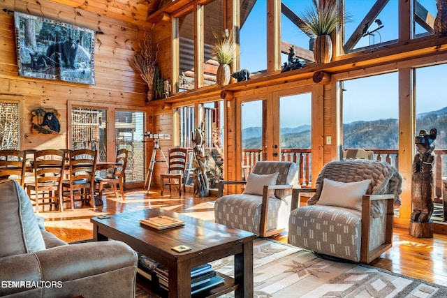 204 Pinnacle Dr, Gatlinburg, TN 37738 - living room with a mountain view, plenty of natural light, hardwood / wood-style floors, wood walls, and a towering ceiling