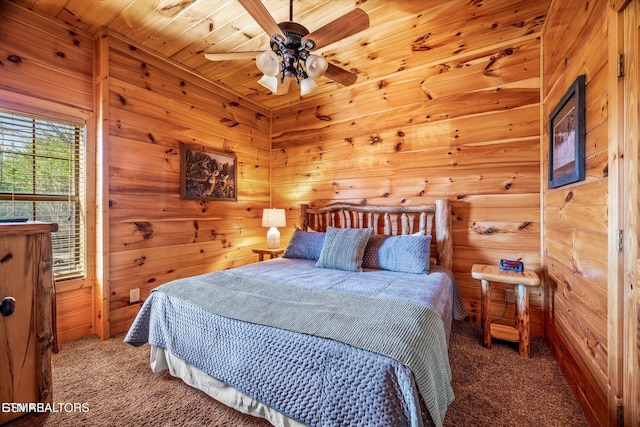 204 Pinnacle Dr, Gatlinburg, TN 37738 - carpeted bedroom featuring wooden walls and a ceiling fan