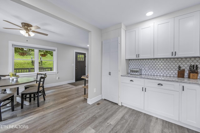 4509 Lifford Ln, Corryton, TN 37721 - kitchen featuring backsplash, baseboards, light wood-type flooring, white cabinets, and recessed lighting