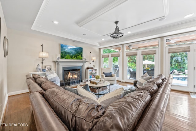 12332 Bonnybridge Ln, Knoxville, TN 37922 - living room featuring a lit fireplace, baseboards, light wood-style floors, ornamental molding, and recessed lighting