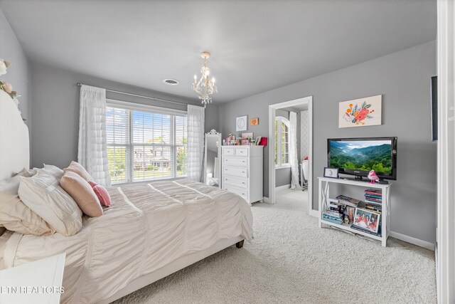 12332 Bonnybridge Ln, Knoxville, TN 37922 - bedroom with multiple windows, a chandelier, carpet flooring, and baseboards