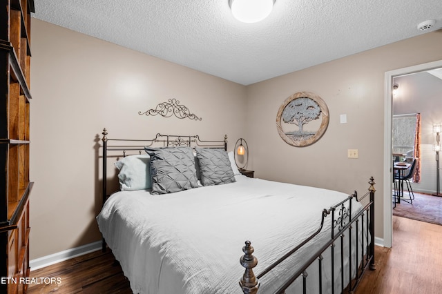 3325 Tekoa Mountain Way, Sevierville, TN 37876 - bedroom featuring dark wood-type flooring, baseboards, and a textured ceiling