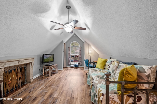 3325 Tekoa Mountain Way, Sevierville, TN 37876 - living room with a textured ceiling, wood finished floors, ceiling fan, baseboards, and lofted ceiling