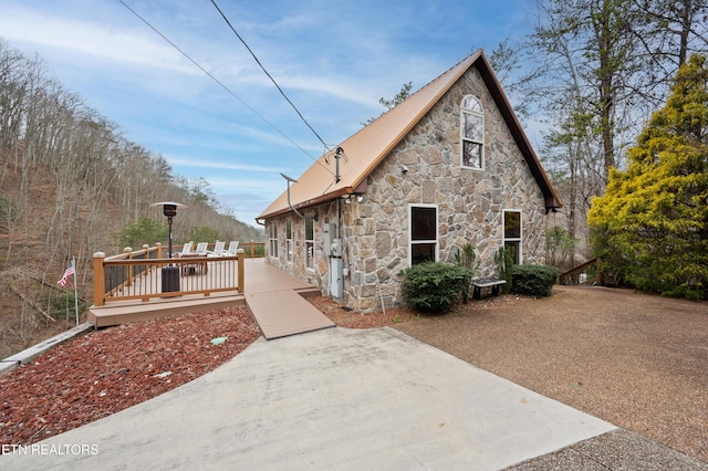 3325 Tekoa Mountain Way, Sevierville, TN 37876 - view of side of home with stone siding, a patio area, a deck, and metal roof