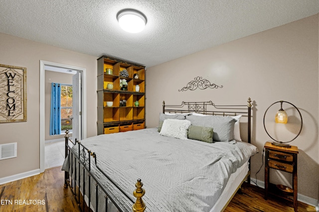 3325 Tekoa Mountain Way, Sevierville, TN 37876 - bedroom with wood finished floors, baseboards, and a textured ceiling