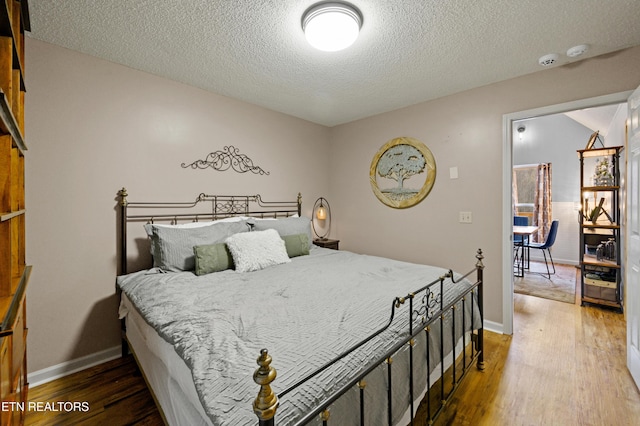 3325 Tekoa Mountain Way, Sevierville, TN 37876 - bedroom featuring wood finished floors, a textured ceiling, and baseboards