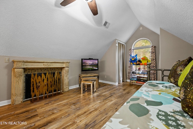 3325 Tekoa Mountain Way, Sevierville, TN 37876 - bedroom with wood finished floors, a textured ceiling, vaulted ceiling, baseboards, and a ceiling fan