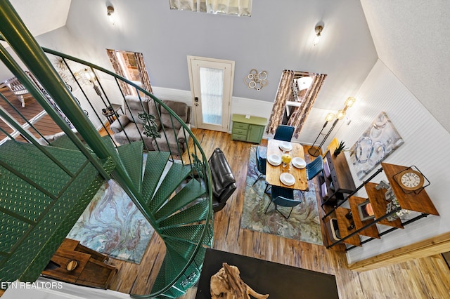 3325 Tekoa Mountain Way, Sevierville, TN 37876 - living room featuring stairway, wood finished floors, high vaulted ceiling, and a wainscoted wall