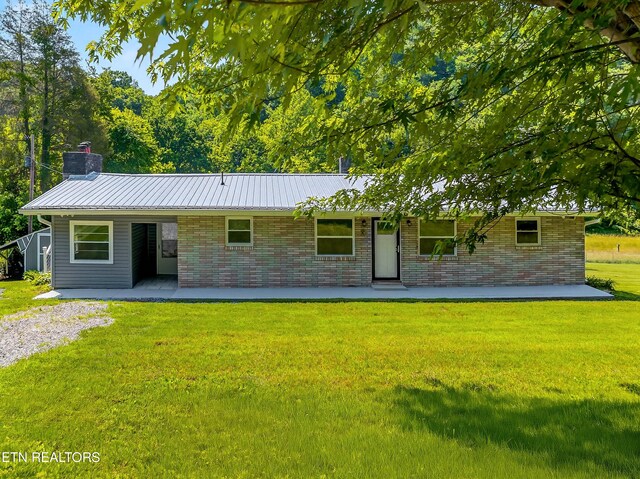 2594 Indian Creek Rd, Thorn Hill, TN 37881 - ranch-style house with a front lawn, a chimney, a patio, a metal roof, and brick siding