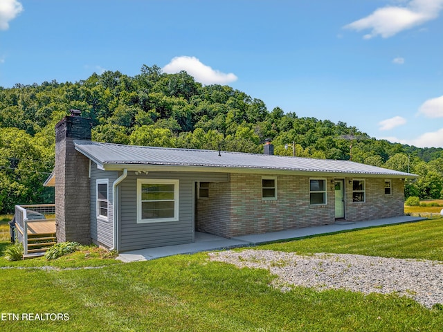 2594 Indian Creek Rd, Thorn Hill, TN 37881 - view of front of home featuring a chimney, a front lawn, a patio area, and a metal roof