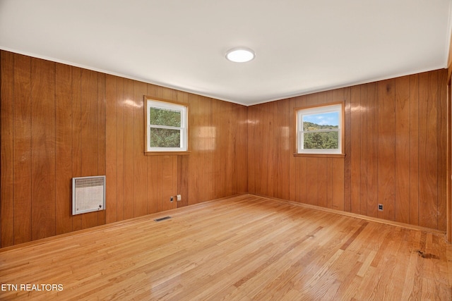 2594 Indian Creek Rd, Thorn Hill, TN 37881 - unfurnished room featuring heating unit, plenty of natural light, wood finished floors, and wooden walls