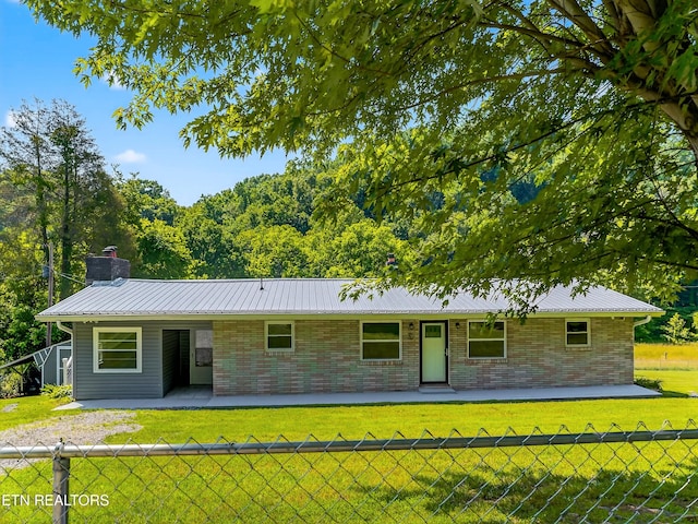 2594 Indian Creek Rd, Thorn Hill, TN 37881 - view of front of house featuring brick siding, a chimney, a metal roof, and a patio area
