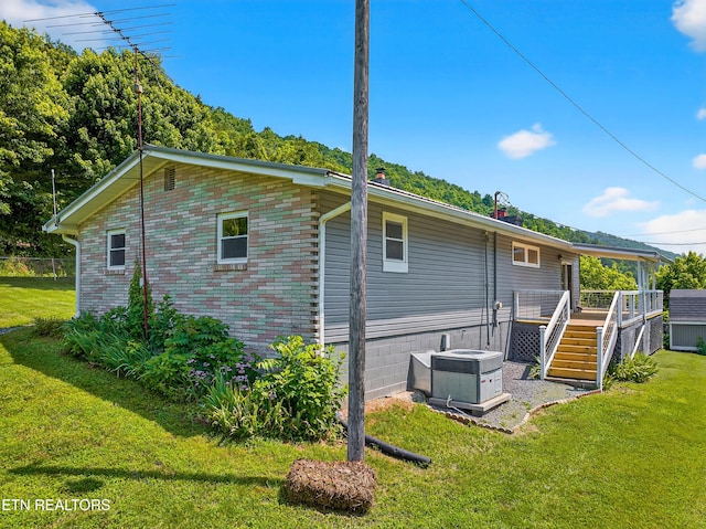 2594 Indian Creek Rd, Thorn Hill, TN 37881 - view of home's exterior with a wooden deck and a lawn