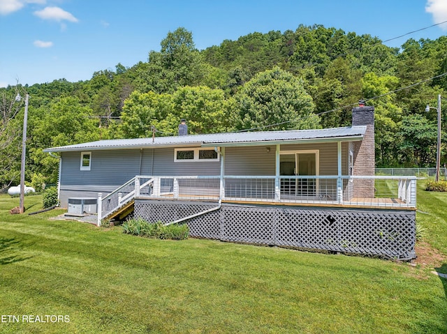2594 Indian Creek Rd, Thorn Hill, TN 37881 - rear view of house featuring a chimney, a lawn, and a wooded view