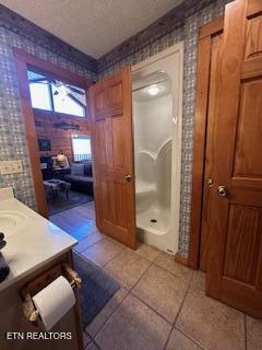 3355 Priscilla Heights Ln, Sevierville, TN 37862 - full bath with tile patterned floors, wallpapered walls, a shower, and vanity