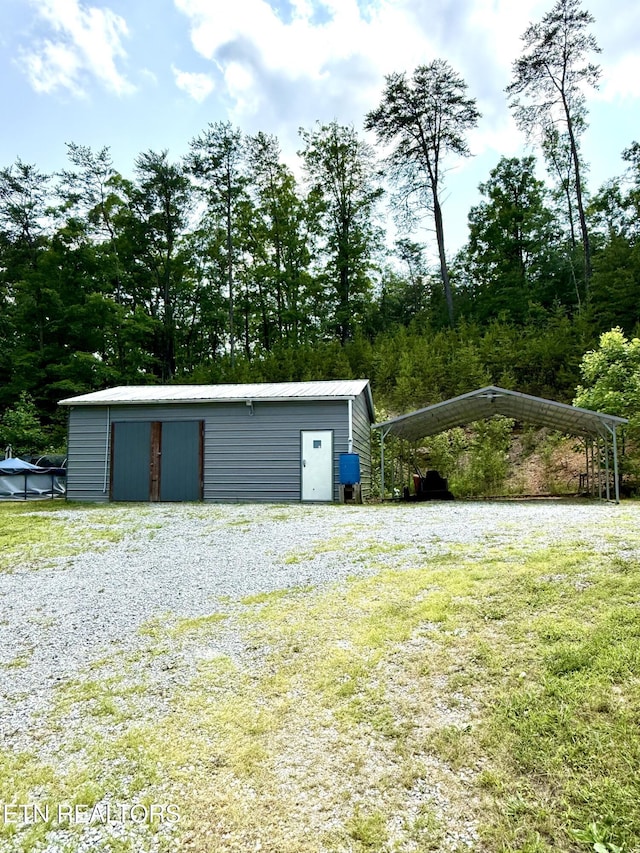 179 Wiggins Rd, Tellico Plains, TN 37385 - garage featuring a detached carport