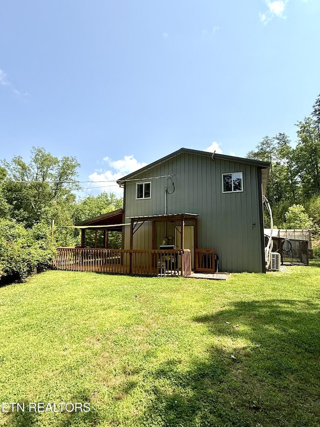 179 Wiggins Rd, Tellico Plains, TN 37385 - rear view of house with a lawn, a deck, and board and batten siding