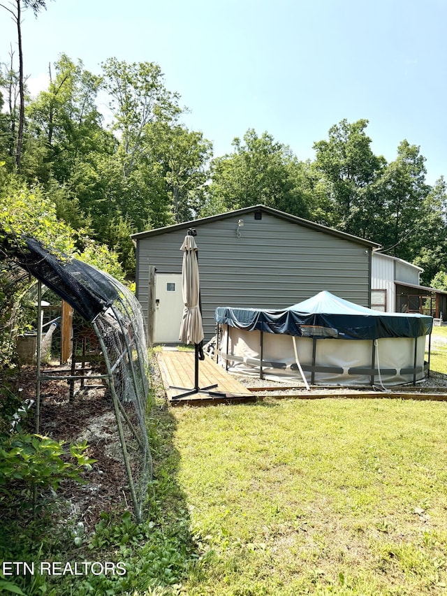 179 Wiggins Rd, Tellico Plains, TN 37385 - back of house featuring a yard, a covered pool, and a wooden deck