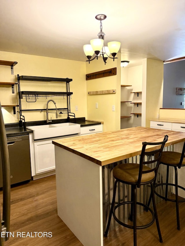 179 Wiggins Rd, Tellico Plains, TN 37385 - kitchen with butcher block counters, a sink, stainless steel dishwasher, open shelves, and white cabinetry