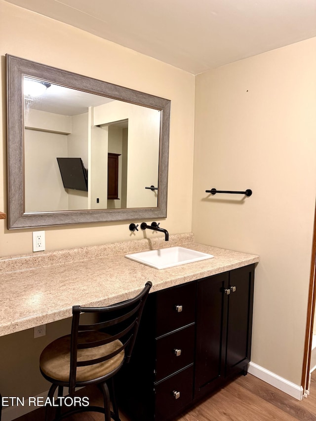 179 Wiggins Rd, Tellico Plains, TN 37385 - bathroom with vanity, wood finished floors, and baseboards