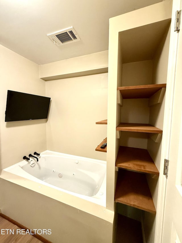 179 Wiggins Rd, Tellico Plains, TN 37385 - full bath with a whirlpool tub and wood finished floors