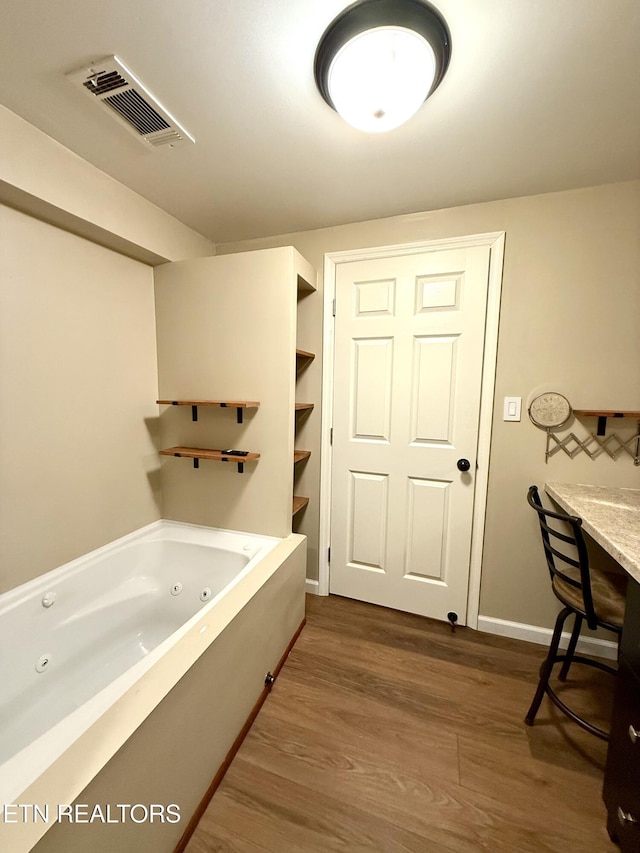 179 Wiggins Rd, Tellico Plains, TN 37385 - bathroom with wood finished floors, a jetted tub, and baseboards