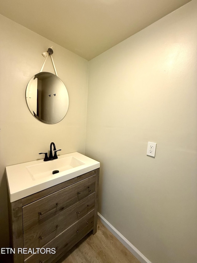 179 Wiggins Rd, Tellico Plains, TN 37385 - bathroom with vanity, baseboards, and wood finished floors