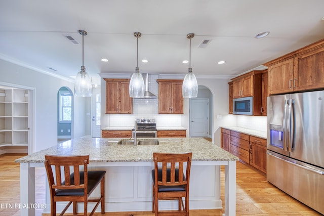 126 Pocola Way, Loudon, TN 37774 - kitchen with stainless steel appliances, arched walkways, ornamental molding, wall chimney exhaust hood, and brown cabinets