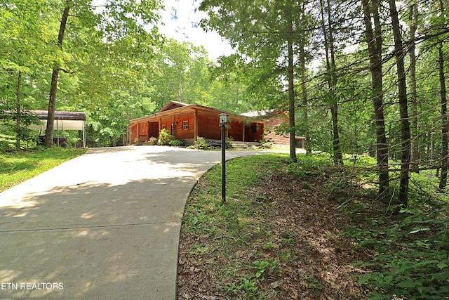 495 Bear Hollow Rd, Oneida, TN 37841 - view of side of property with concrete driveway and a forest view