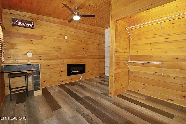 495 Bear Hollow Rd, Oneida, TN 37841 - unfurnished living room with a fireplace, wood walls, wood finished floors, ceiling fan, and wooden ceiling