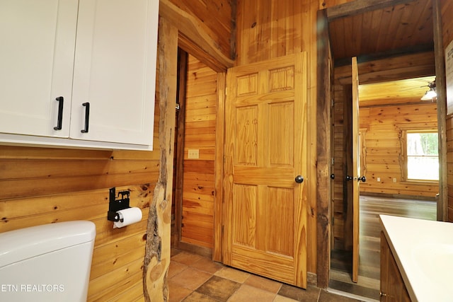 495 Bear Hollow Rd, Oneida, TN 37841 - bathroom with wood walls, vanity, and toilet