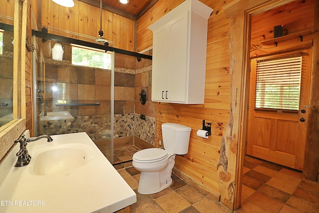 495 Bear Hollow Rd, Oneida, TN 37841 - full bathroom with wood walls, toilet, a shower stall, stone tile floors, and vanity
