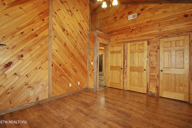 495 Bear Hollow Rd, Oneida, TN 37841 - unfurnished bedroom featuring wood walls, wood finished floors, and lofted ceiling