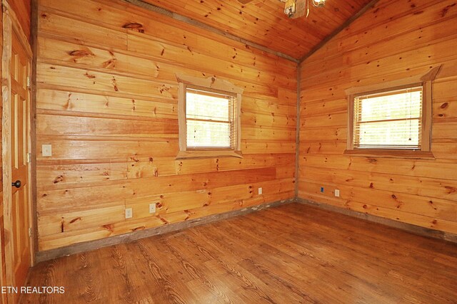 495 Bear Hollow Rd, Oneida, TN 37841 - unfurnished room featuring lofted ceiling, healthy amount of natural light, wood finished floors, wooden walls, and wooden ceiling