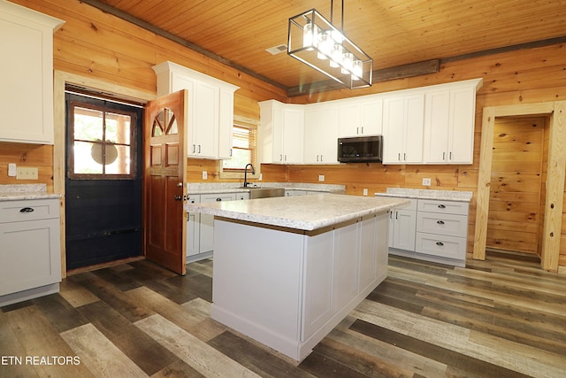 495 Bear Hollow Rd, Oneida, TN 37841 - kitchen with wood ceiling, wood walls, dark wood-type flooring, light countertops, and white cabinets