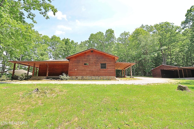 495 Bear Hollow Rd, Oneida, TN 37841 - back of house featuring a lawn, driveway, and an outbuilding