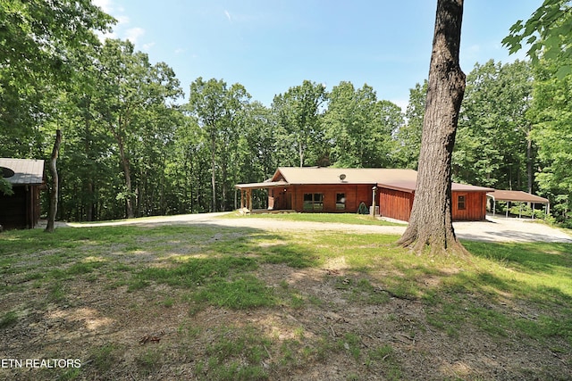 495 Bear Hollow Rd, Oneida, TN 37841 - view of front of home with a carport and a forest view