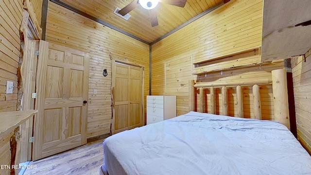 495 Bear Hollow Rd, Oneida, TN 37841 - bedroom featuring wood walls, wooden ceiling, wood finished floors, and a ceiling fan