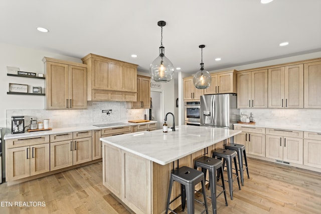 888 Smokey Quartz Blvd, New Tazewell, TN 37825 - kitchen with appliances with stainless steel finishes, light brown cabinets, recessed lighting, a kitchen breakfast bar, and tasteful backsplash